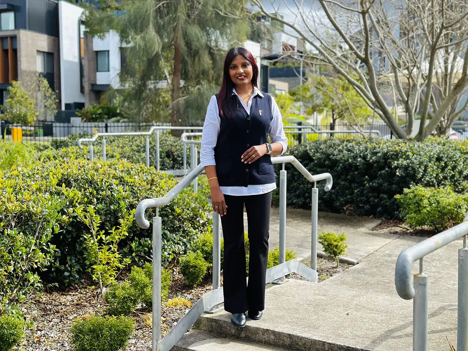 Support worker Achini smiling at the camera