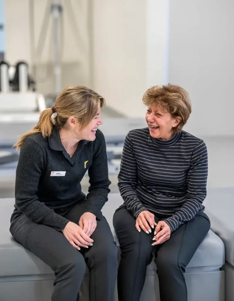 Royal Rehab Group client and staff member laughing together